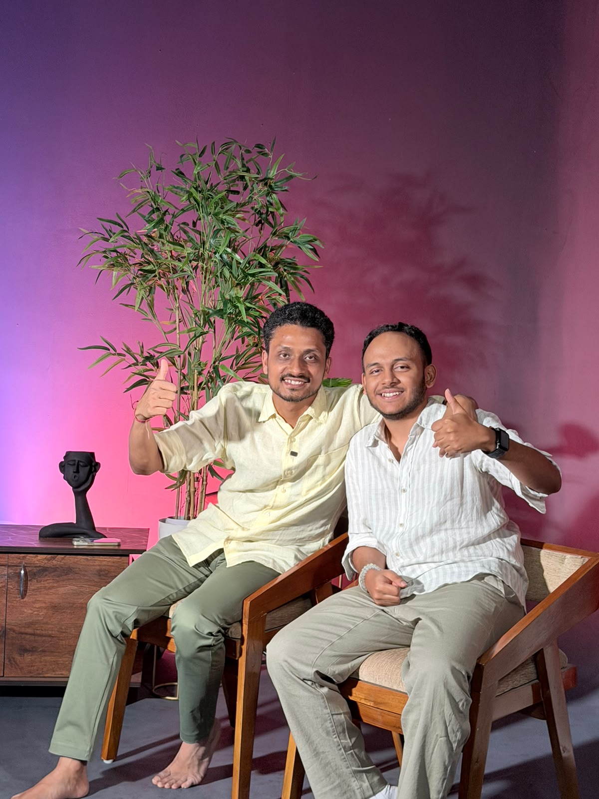 Aankit and Shinjan, the co-founders of Something, sitting side by side and smiling with thumbs up.